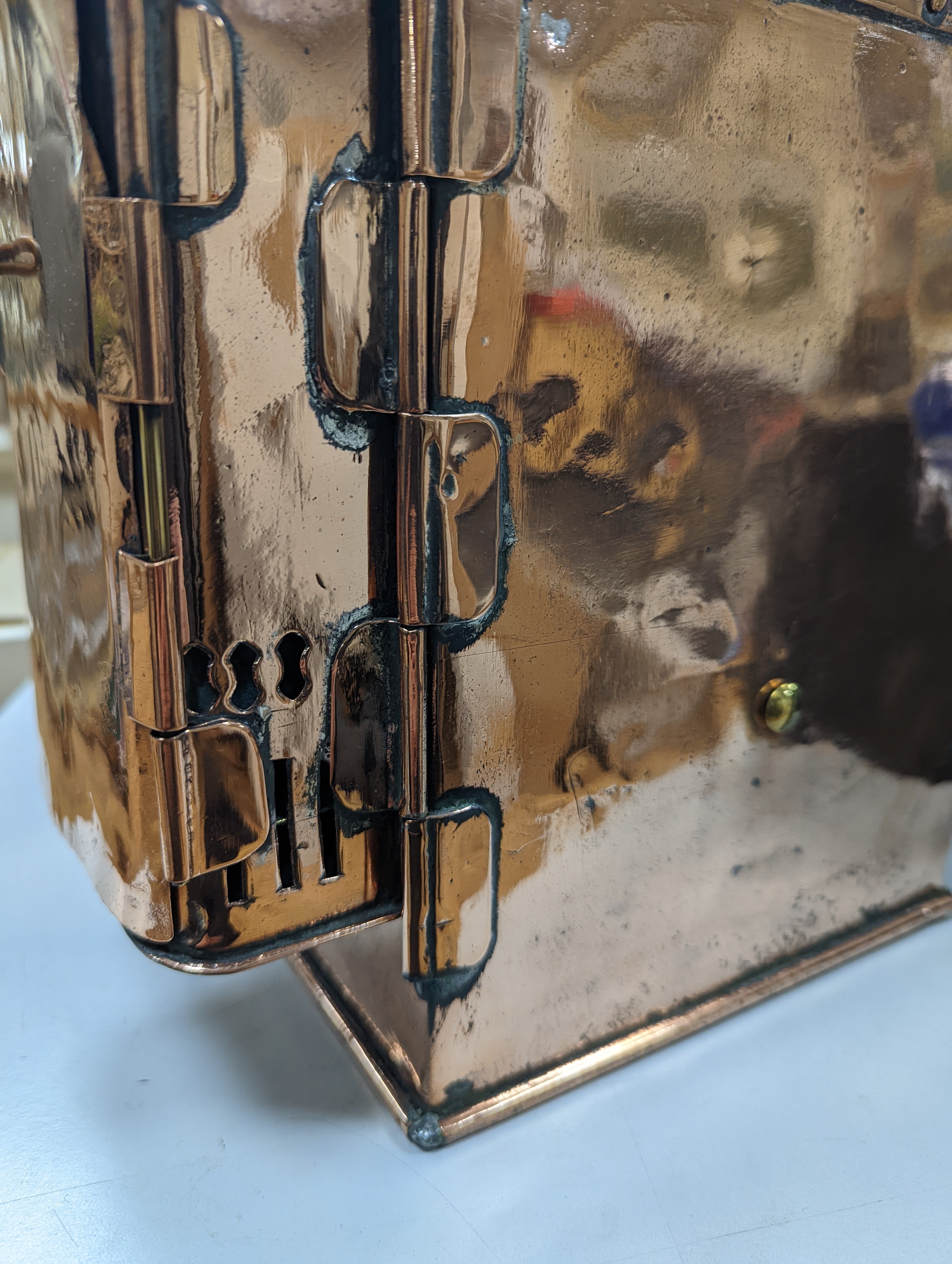 A copper ship's binnacle compass, a brass oil lamp, a brass jug and a copper kettle